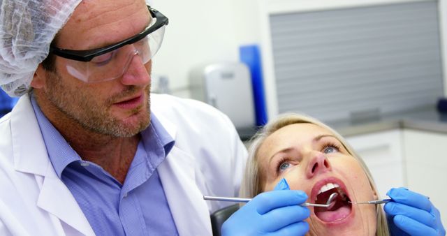 Dentist examining a female patient with dental tools in dental clinic 4k