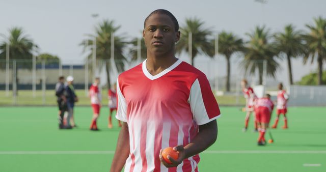 Confident Young Male Hockey Player with Team on Field - Download Free Stock Images Pikwizard.com