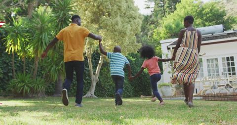 Happy African American Family Playing in Backyard
