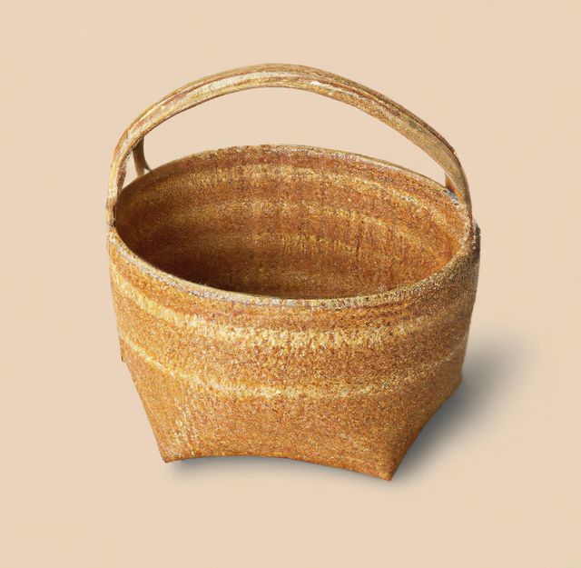 Image of close up of empty traditional wicker basket on cream background. Tradition and hand made procucts concept.