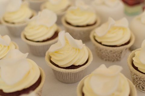 Assorted vanilla cupcakes with elegant white wrappers