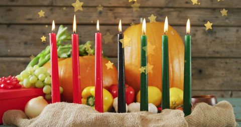 Kwanzaa candle arrangement with fruits and vegetables