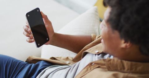 Relaxed African American Man Browsing Smartphone at Home - Download Free Stock Images Pikwizard.com