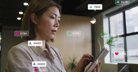 Person Engaged with Social Media Network on Tablet Inside Office