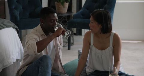 Interracial Friends Enjoying Wine and Conversation at Home
