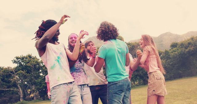 Happy Friends Celebrating Holi with Colored Powder in Park - Download Free Stock Images Pikwizard.com