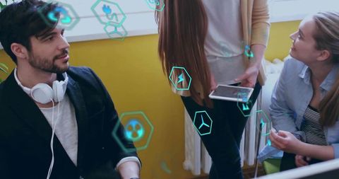 Young professionals collaborating with tablet and ar holograms in bright creative studio