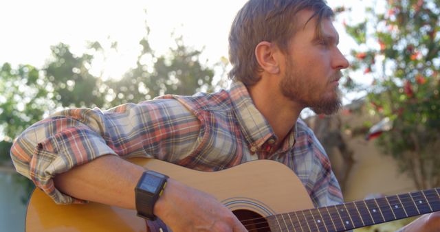 Man Playing Acoustic Guitar Outdoors at Sunset - Download Free Stock Images Pikwizard.com