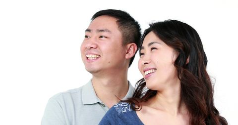 Young Asian Couple Smiling Joyfully with Copy Space