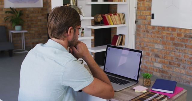 Young Man Working from Home with Laptop in Modern Home Office - Download Free Stock Images Pikwizard.com