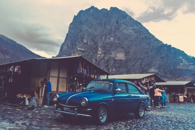 Vintage Volkswagen Car in Andean Village with Mountain Backdrop at Dusk - Download Free Stock Photos Pikwizard.com