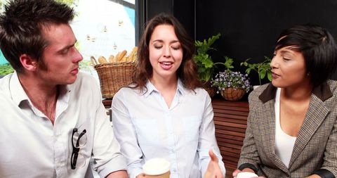 Young adults having lively conversation in cafe