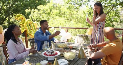Friends Celebrating Birthday in Sunlit Garden
