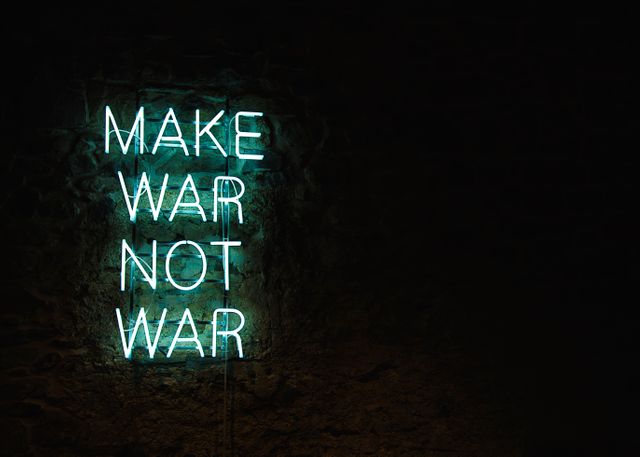 Glowing neon sign against dark background, displaying text 'Make War Not War', conveying a profound message about peace and opposition to conflict. Ideal for use in articles, posters, social media posts, anti-war campaigns, inspirational content, and wall art.