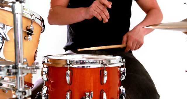 Drummer playing his drum kit on white background