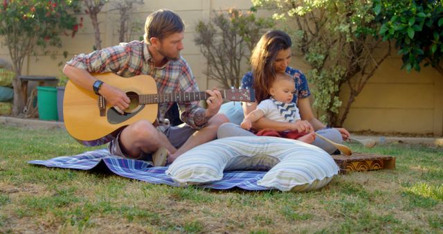 Family spending quality time outdoors with guitar and child - Download Free Stock Images Pikwizard.com