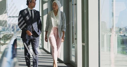 Diverse Business Professionals Walking in Modern Office Corridor