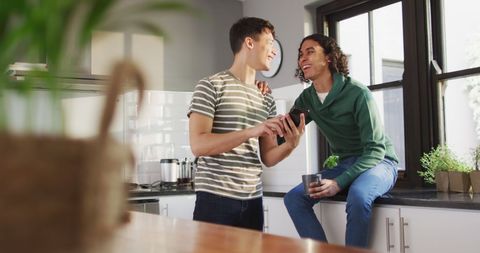 Couple Enjoying Time Together with Smartphone in Modern Kitchen