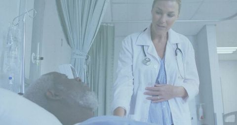 Compassionate Doctor Examining Elderly Patient in Hospital Ward