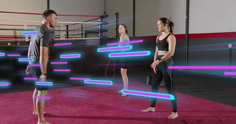 Trio training with jump ropes in boxing gym with neon motion streaks and coaching teamwork