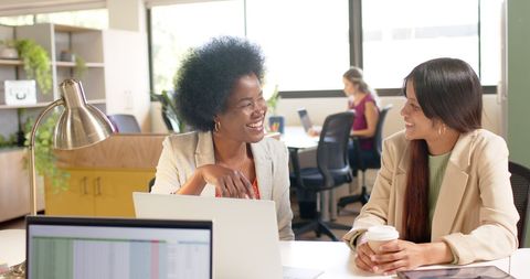 Diverse Female Creative Colleagues Discussing in Office Setting