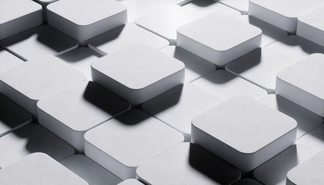 Raised rounded square blocks casting dramatic shadows on minimal grayscale grid