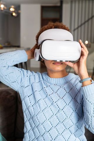 Woman using virtual reality headset in modern home environment