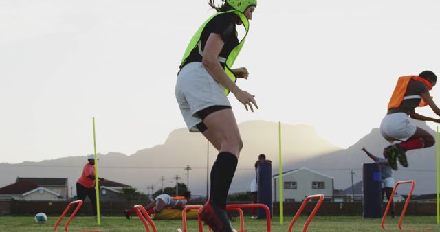 Women's sports team engaged in outdoor training with hurdles and drills - Download Free Stock Images Pikwizard.com