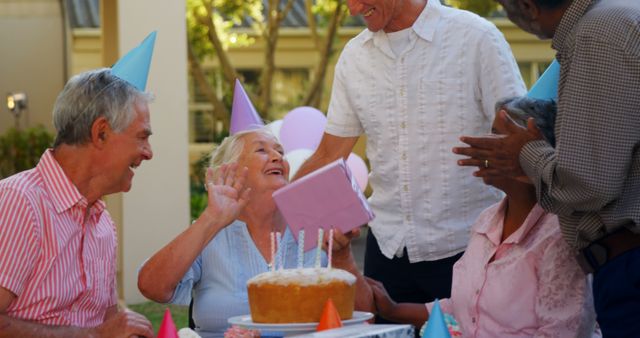 Joyful Seniors Celebrating Outdoor Birthday Party with Cake and Gifts - Download Free Stock Images Pikwizard.com