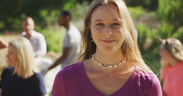 Smiling Young Woman Enjoying Outdoor Gathering on Sunny Day - Download Free Stock Images Pikwizard.com