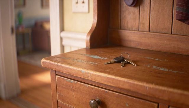 Rustic entryway keys resting on weathered wooden bench with coat hook, warm vintage charm