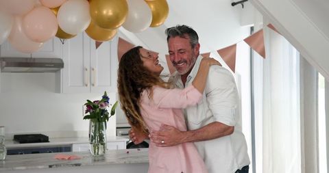 Happy Couple Celebrating in Decorated Kitchen