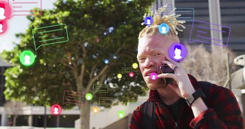 African american man chatting on smartphone with virtual bubbles
