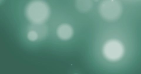 Hypnotic glowing white spots on green background