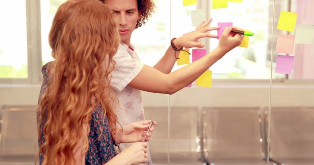 Young Professionals Brainstorming with Sticky Notes in Office - Download Free Stock Images Pikwizard.com