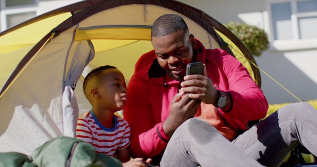 Father and son bonding in backyard camping tent - Download Free Stock Images Pikwizard.com