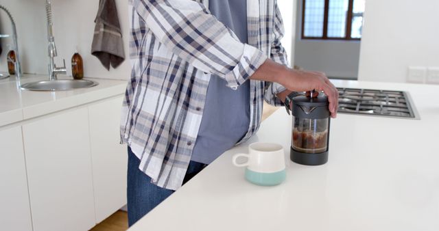 Man Brewing Coffee with French Press in Modern White Kitchen - Download Free Stock Images Pikwizard.com