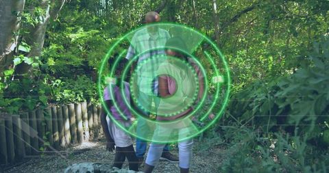 Multigenerational family walking sunlit forest trail with green hud overlay
