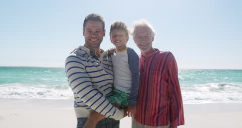 Happy Multigenerational Family Playing at Sunny Beachside