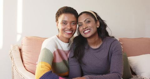 Diverse female friends enjoying cozy moment indoors