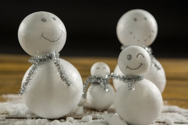 Artificial snowman decoration on table against black background