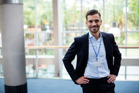 Smiling Businessman Posing in Modern Conference Center