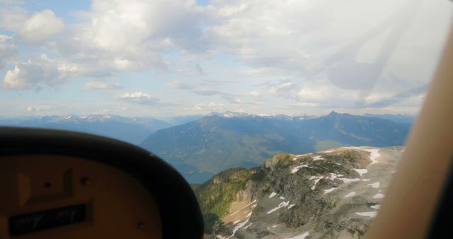 Aerial view of mountainous landscape with clouds during flight - Download Free Stock Images Pikwizard.com