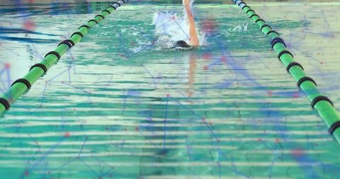 Swimmer performing powerful strokes in pool lane