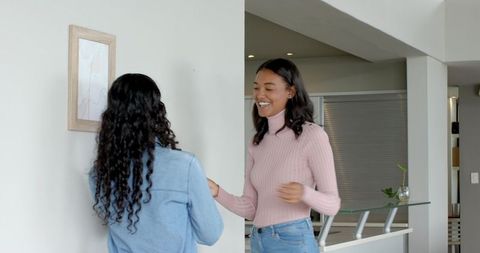 Two Friends Sharing Keys in Modern Kitchen