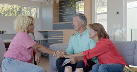 Senior Couple Bonding with Family at Home Smiling and Laughing