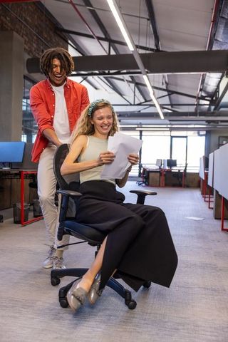 Playful Coworkers Engaging in Fun Activity in Modern Office Space