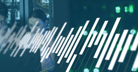 Female Network Technician Monitoring Server Performance Using Laptop with Graph Overlay