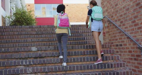 Diverse Teenage Girls Walking Up School Stairs Vibrant Sunlit Day