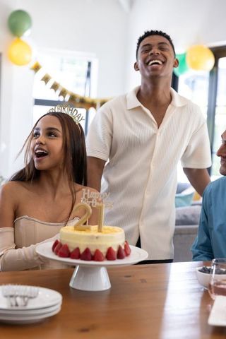 Friends celebrating a 21st birthday with cake and decorations